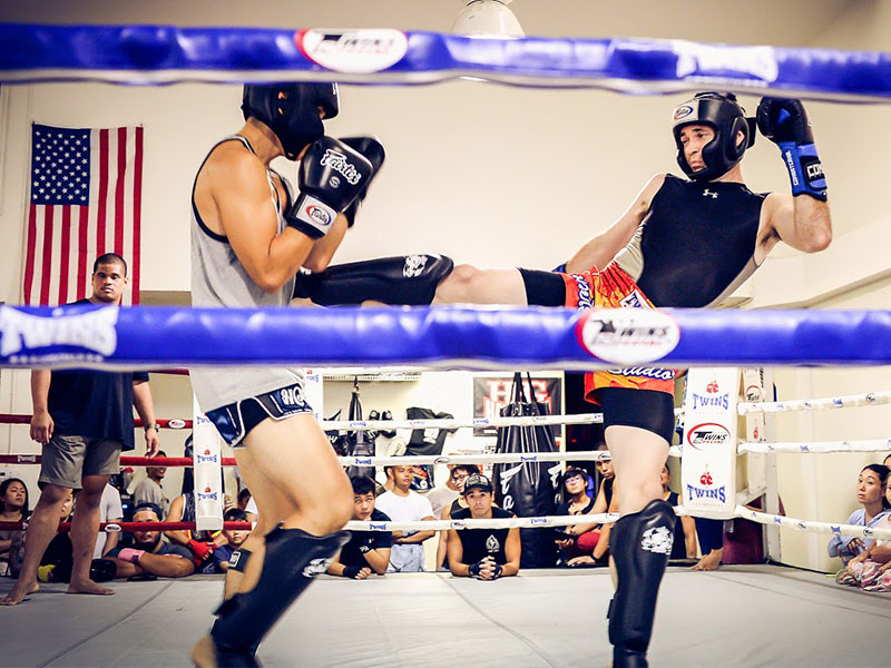 Jack showcasing powerful techniques during a Muay Thai fight, demonstrating skill and precision in the ring.