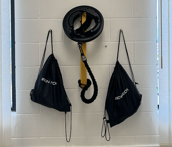 Iron Neck training gear in the Jackupuncture membership area, promoting neck strength and rehabilitation, captured with Membership-Gear-Snap.