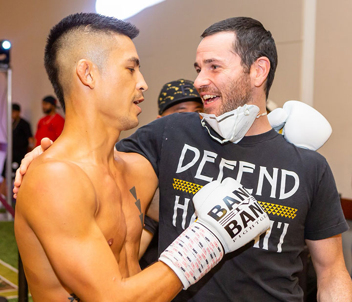 Jackupuncture founder celebrating with a Muay Thai fighter post-match, showcasing the synergy between sports performance and recovery, captured with Sports-Jack.