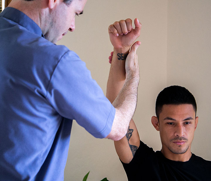 Jackupuncture practitioner assisting a client with targeted stretching exercises to improve flexibility and mobility, captured with Stretching-Snap.