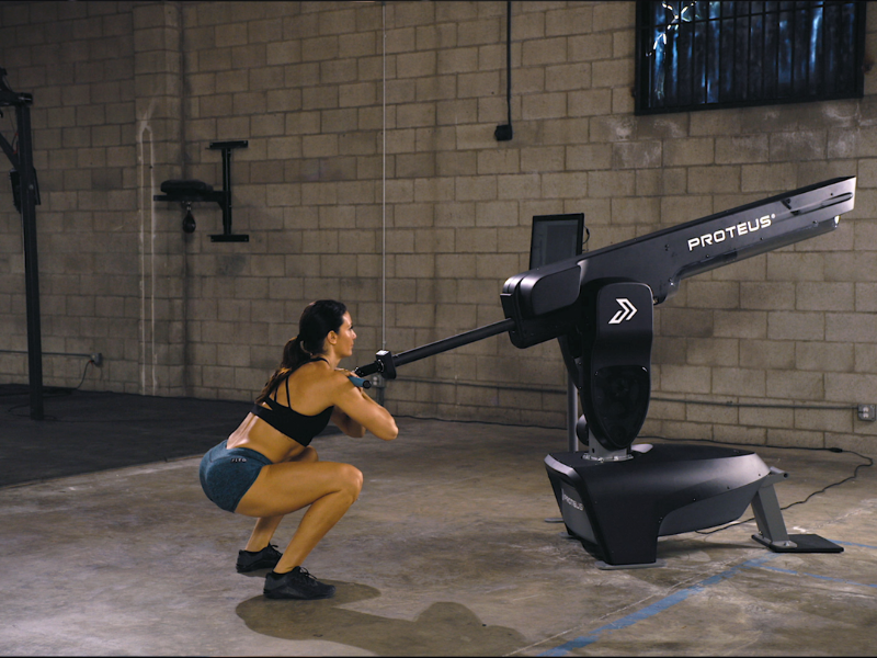 Fitness enthusiast utilizing the Proteus Motion machine for advanced strength and performance training in a modern gym setting.