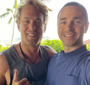 Mike Morelli with Jack, fostering a connection in a serene tropical setting.